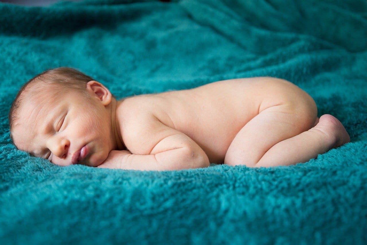Nappy Rash Prevention and Treatment 1 Nappy Rash Prevention and Treatment | Newborn baby sleeping on a soft teal blanket.