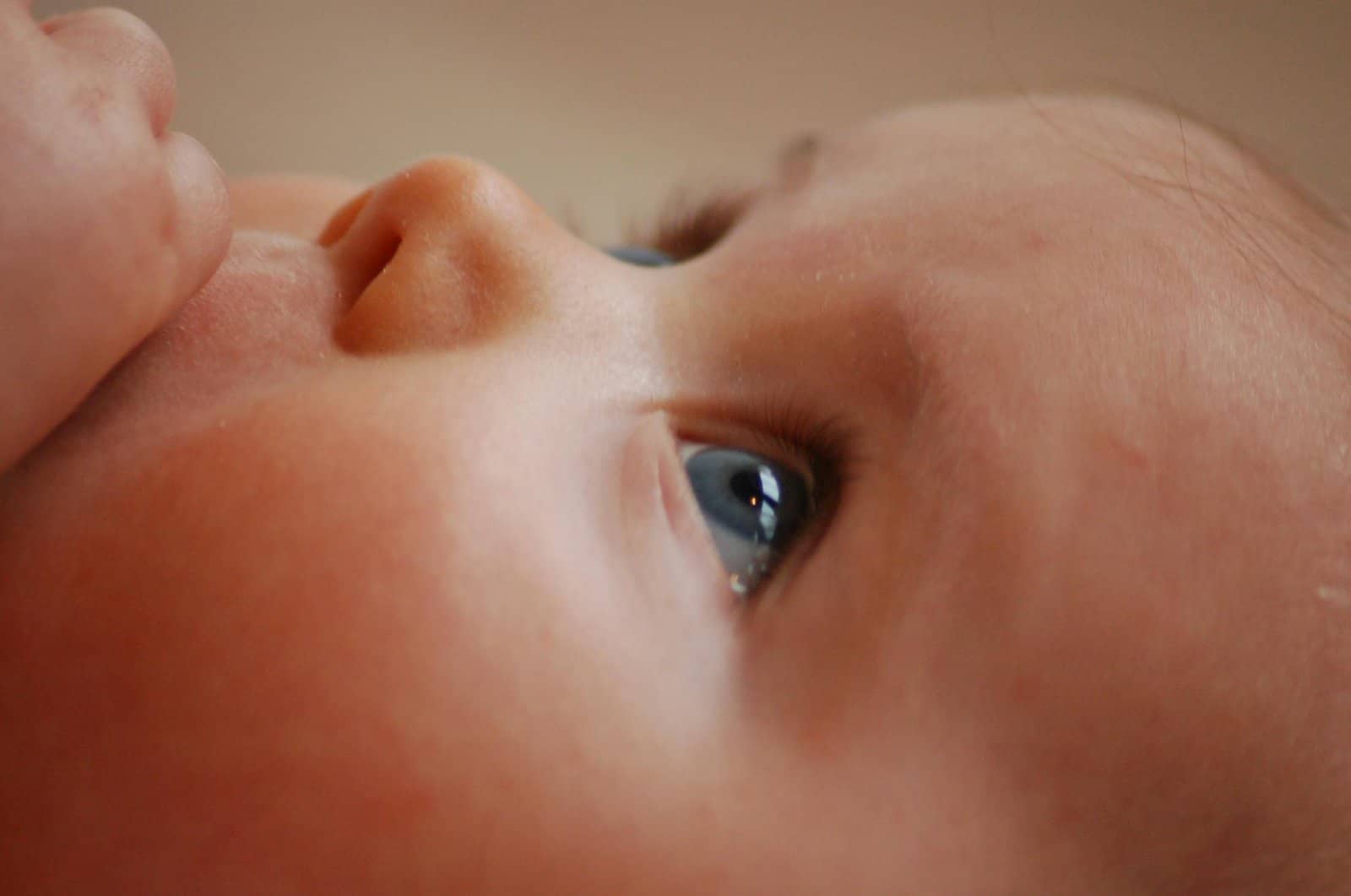 Building a Bond with Your Baby: Close-up of a baby's face, focusing on their blue eye and delicate skin.