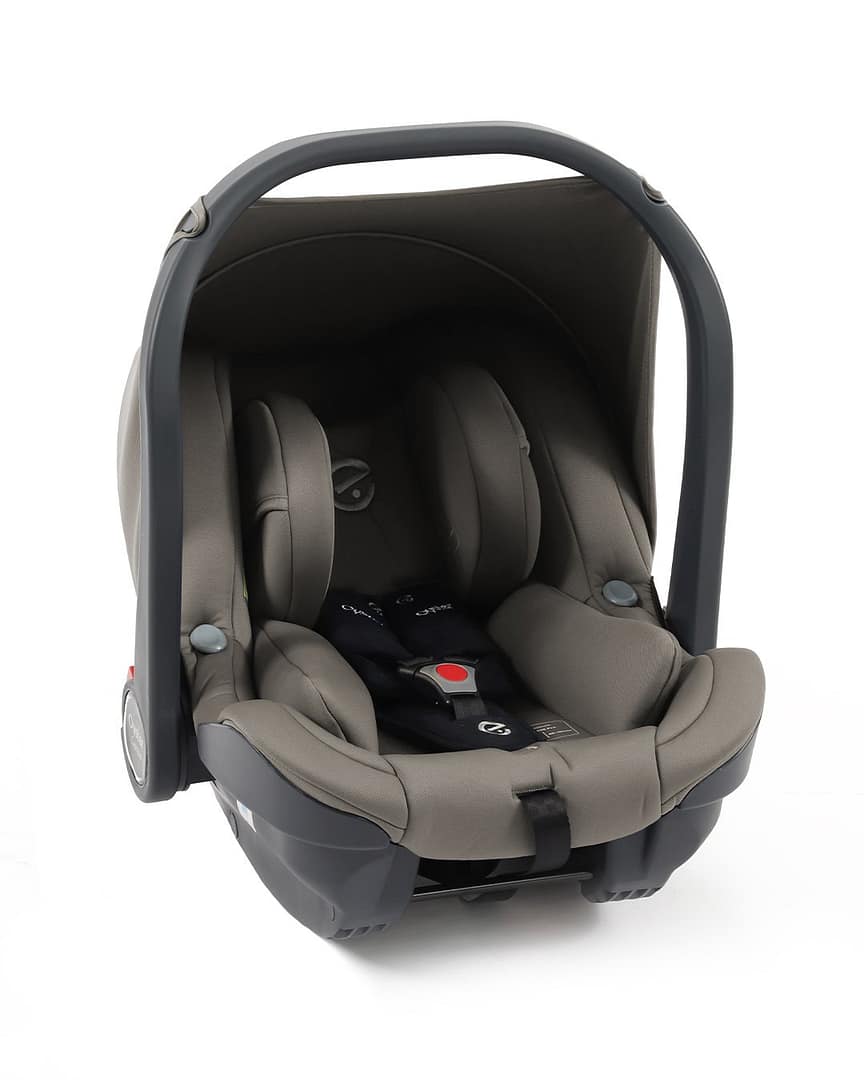Babystyle Oyster Capsule Group 0+ i-Size Infant Car Seat 3 Babystyle Oyster Capsule Group 0+ i-Size Infant Car Seat: A grey infant car seat with a protective canopy and a black harness buckle, placed on a white background.